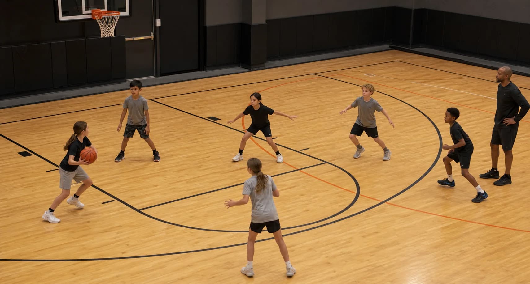 Children playing a supervised three-on-three learning game